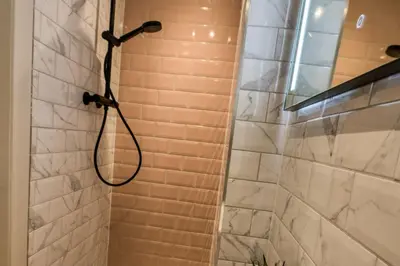 a shower with a shower head in a bathroom at 9 Bedroom all Ensuite- Exclusive Use in Auchterarder