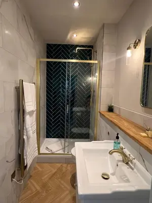 a bathroom with a shower and a white sink at 9 Bedroom all Ensuite- Exclusive Use in Auchterarder
