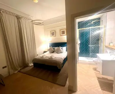 a bedroom with a bed and a large window at 9 Bedroom all Ensuite- Exclusive Use in Auchterarder