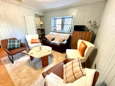 a living room with a couch and chairs and a table at 'Flora' in ApartNest Auchterarder in Auchterarder
