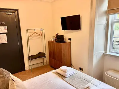 a bedroom with a bed and a flat screen tv at 'Mac' in ApartNest Auchterarder in Auchterarder