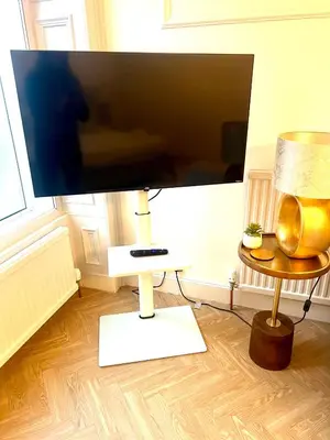 a flat screen tv sitting on top of a table at 'Blair' in ApartNest Auchterarder in Auchterarder