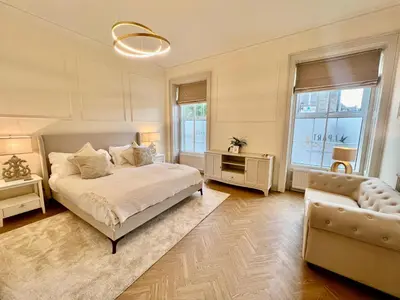 a bedroom with a bed and a couch and a chair at 'Blair' in ApartNest Auchterarder in Auchterarder