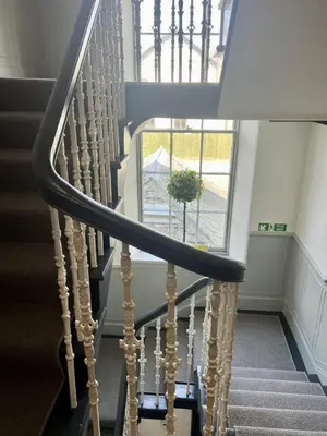 a spiral staircase with a plant in a window at 'Blair' in ApartNest Auchterarder in Auchterarder