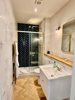 a white bathroom with a sink and a shower at 'Gordon' in ApartNest Auchterarder in Auchterarder