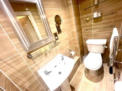 a bathroom with a toilet and a sink and a mirror at 'Maisie' in ApartNest Auchterarder in Auchterarder