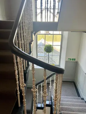 a spiral staircase with a plant in a window at 'Clyde' in ApartNest Auchterarder in Auchterarder