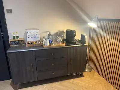 a wooden cabinet with a light on top of it at 'Clyde' in ApartNest Auchterarder in Auchterarder