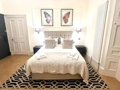 a bedroom with a bed with two towels on it at 'Douglas' in ApartNest Auchterarder in Auchterarder