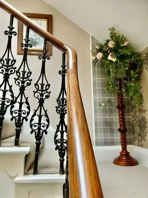 a stairway with a vase with a plant at Above & Beyond at Warriston Lodge in Moffat