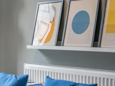 a shelf above a bed with pictures on it at West End Cosy Pop of Colour - Pass the Keys in Glasgow