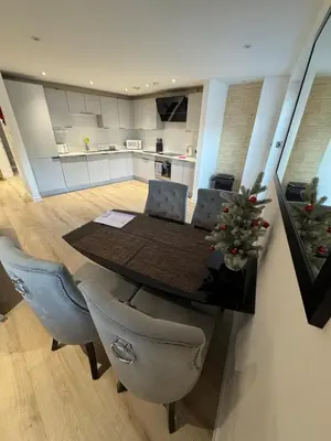 a kitchen and dining room with a table and chairs at KM Granton Apartment in Edinburgh