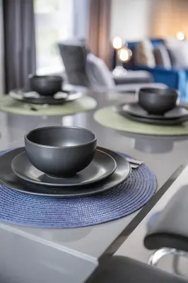 a table with black bowls and plates on it at Quiet 2 bedroom gem in Stirling in Bridge of Allan