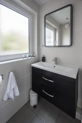 a bathroom with a sink and a mirror at Quiet 2 bedroom gem in Stirling in Bridge of Allan
