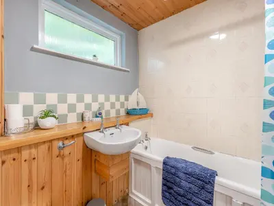 a bathroom with a sink and a bath tub at Carraig-Dhubh South - Uk47124 in Whiting Bay