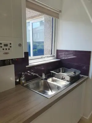 a kitchen counter with a sink and a window at THE ELFIN- Lovely 1 Bedroom - Free Parking in Bridge of Allan