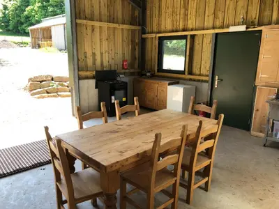 a wooden table and chairs in a kitchen at The Bothy and Wagon at Pitmeadow Farm in Perth