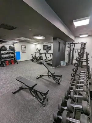 a gym with several rows of treadmills and weights at Student Only Merchant Studios in Glasgow in Glasgow
