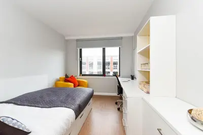 a bedroom with a bed and a desk and a window at Student Only Merchant Studios in Glasgow in Glasgow