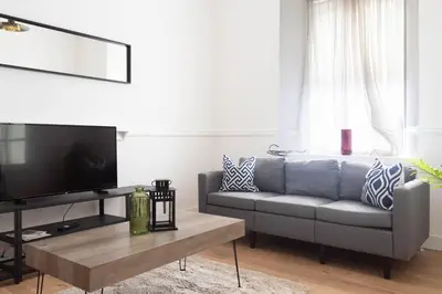 a living room with a couch and a coffee table at 3 BDR House At Caledonia Luxe Stays Short Lets & Serviced Accommodation Tillicoultry in Tillicoultry