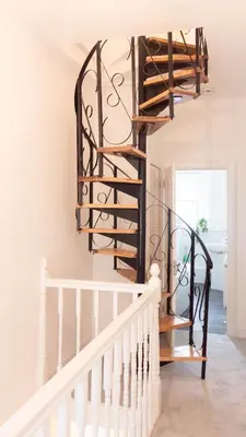 a spiral staircase in a house with white walls at 3 BDR House At Caledonia Luxe Stays Short Lets & Serviced Accommodation Tillicoultry in Tillicoultry