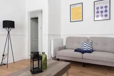 a living room with a couch and a table at 3 BDR House At Caledonia Luxe Stays Short Lets & Serviced Accommodation Tillicoultry in Tillicoultry