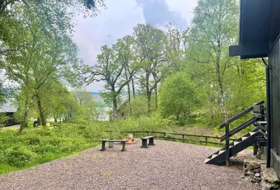 a group of benches sitting in a park at Seil Log Cabin in Dalavich