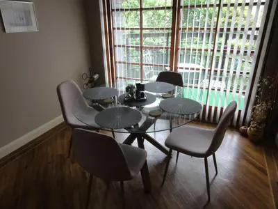 a dining room with a table and chairs and a window at Orchard Brae in Edinburgh