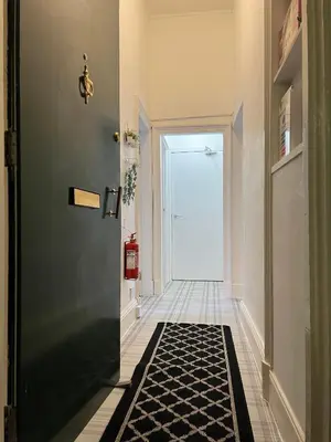 a hallway with a door and a black and white rug at Spacious boutique two-bedroom apartment next to the castle in Edinburgh