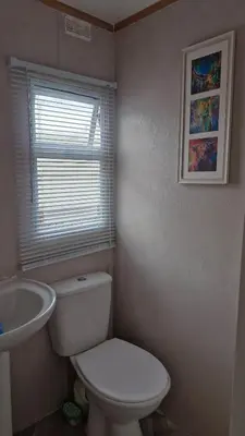 a bathroom with a white toilet and a sink at Static Caravan situated at Wigbay, Stranraer in Stranraer