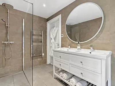 a bathroom with a white sink and a mirror at Aos Sí - Wellness - Jacuzzi - Lodges in Ballachulish