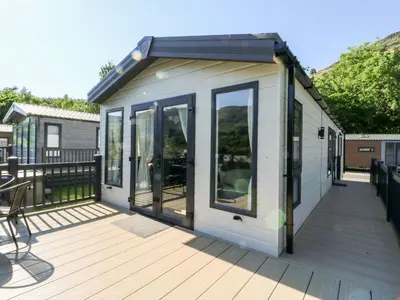 a tiny house with a roof on a deck at Saorsa in Crieff