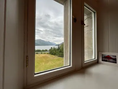 a window in a room with a view of the water at St John's Old Rectory in Glencoe