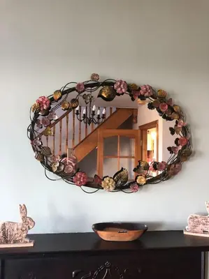 a circular mirror on a wall with a staircase at Beachside House Rathlin Island in Rathlin Island