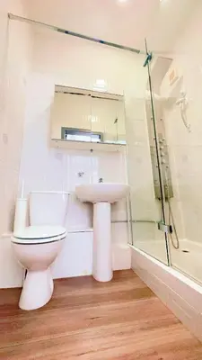 a bathroom with a toilet and a sink and a shower at River Haven Edinburgh in Edinburgh