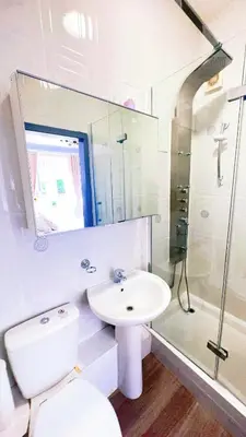 a bathroom with a sink and a toilet and a mirror at River Haven Edinburgh in Edinburgh