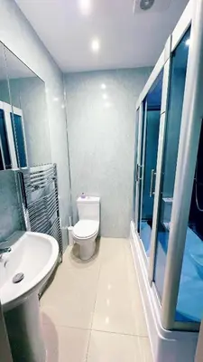 a bathroom with a white toilet and a sink at River Haven Edinburgh in Edinburgh