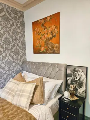 a bedroom with a bed and a painting on the wall at River Haven Edinburgh in Edinburgh