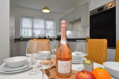 a bottle of wine sitting on a table with glasses at Kilin in Lochgilphead