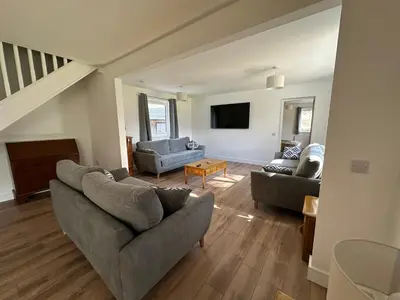 a living room with two couches and a tv at Highland Hideaway in Fort William