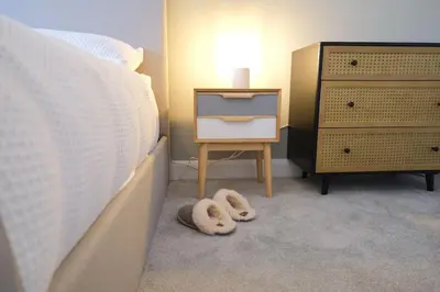 a bedroom with a bed and a dresser with a night stand at Lang Toon House - 3 bedrooms in Auchterarder