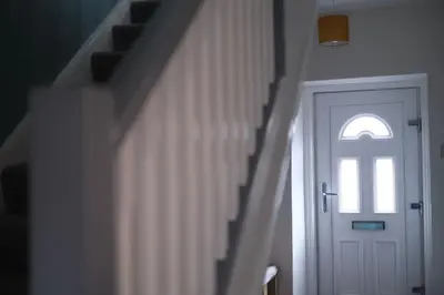a hallway with a white door and a window at Lang Toon House - 3 bedrooms in Auchterarder