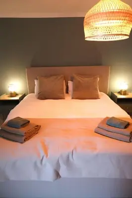 a bedroom with a large bed with two towels on it at Lang Toon House - 3 bedrooms in Auchterarder
