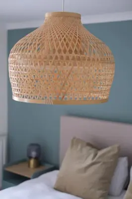 a lamp hanging over a bed with a pillow at Lang Toon House - 3 bedrooms in Auchterarder