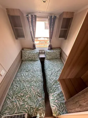 a small room with two beds in a caravan at Swift 3-Bedroom Caravan Located in Uddingston, Glasgow at Maryville Caravan Site in Uddingston