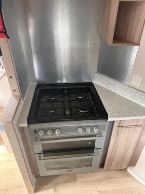 a stove in a kitchen with a counter top at Swift 3-Bedroom Caravan Located in Uddingston, Glasgow at Maryville Caravan Site in Uddingston