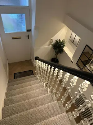 a stairway with a potted plant sitting on top of it at Luxury High Street Apartment in Moffat