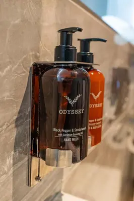 two bottles of soap are sitting on a counter at DeiRa Hotel & Apartments in Prestwick