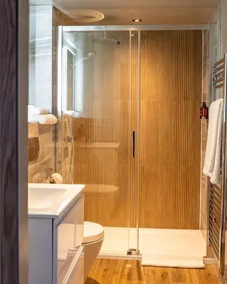 a bathroom with a shower and a toilet and a sink at DeiRa Hotel & Apartments in Prestwick