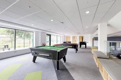 a billiard room with two pool tables and couches at Abodus St James Glasgow in Glasgow
